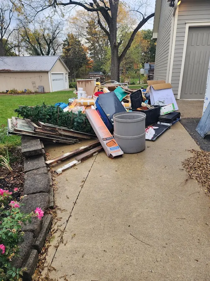 Dumpster being loaded with debris for Estate Cleanout Dumpster Rental in Moulton